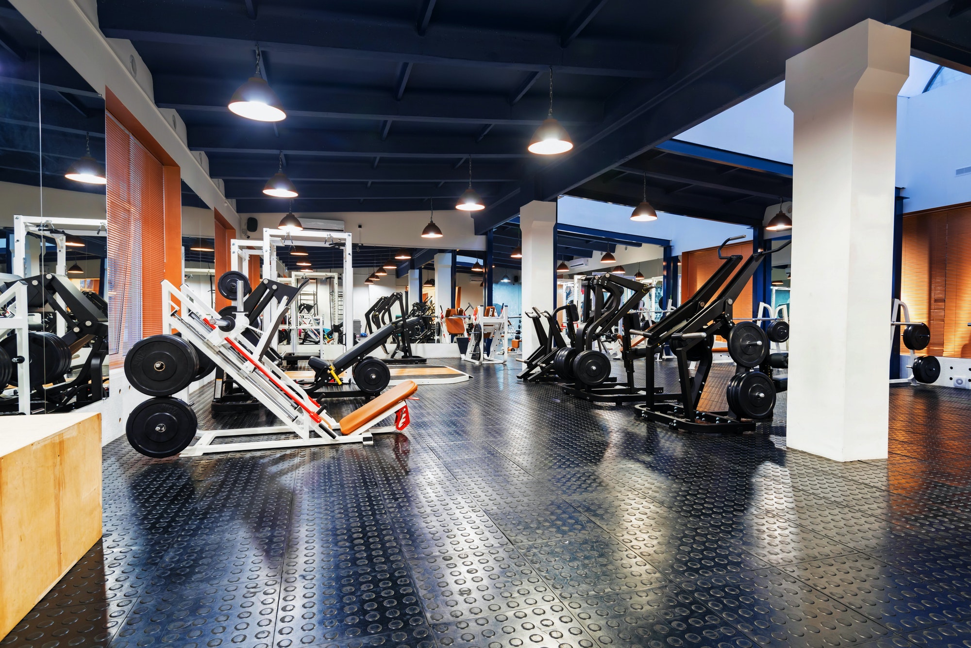 New fitness machines in modern gym interior